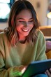© spyrakot - Community manager smiling at tablet in cozy home office with colorful feedback glow