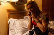 © Rawpixel.com - Person talking phone evening room