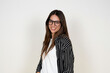 © Daniel - Friendly young woman smiles confidently while wearing glasses and a striped shirt in a bright studio portrait. Casual, approachable look conveying professionalism, warmth and modern style for lifestyl