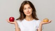 © Liudmyla - Young woman choosing between apple and sweet donut, representing healthy and unhealthy food, copy space