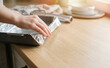 © MT - Woman lining a baking pan with aluminum foil in a bright modern kitchen, preparing for cooking or baking a homemade meal