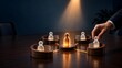 © wahyuni - Hand placing employee figure into team structure with glowing leader and connected workers on wooden table