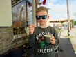 © Cavan Images - Cool kid with sunglasses eating ice cream outdoors