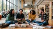 © Martarina - Group of happy diverse students talking and studying on floor in modern university library