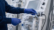 © Creative man - premium medical photo, close-up of a healthcare professional's gloved hands preparing sterile tubing and a modern plasmapheresis machine before treatment, clean blood purification clinic