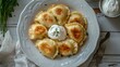 © Nataliya - fried vareniki with sour cream—Polish food