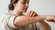 © Musarrof - Young Woman Scratching a Red Itchy Skin Rash on Her Forearm, Eczema or Allergy Concept