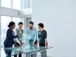 © MUHAMMADJAYA - Diverse multi-ethnic team of business professionals interacting with a holographic glass interface showing a glowing 3D digital brain and icons in a bright modern office setting.