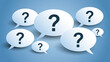 © Akash - White speech bubbles with question marks glowing on a blue background. Ideal for customer support and FAQ concepts.