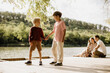 © BGStock72 - Two young boys enjoy friendship at a peaceful lakeside in the afternoon sun