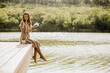 © BGStock72 - Relaxing by the water with a good book on a sunlit lakeside afternoon