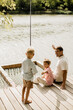 © BGStock72 - Joyful moments by the serene lake with family enjoying a sunny day