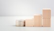 © Richard - Coin stack beside ascending wooden blocks for financial growth