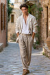 © Chainat - Mediterranean Charm A stylish young man exudes effortless confidence as he strolls down a sun-drenched cobblestone street in a picturesque Mediterranean village.