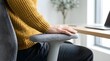 © PixelPulse - Close-Up Of A Person Sitting At Desk With Armrest On Chair