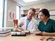 © Shara - Medical doctor and student nurse examining a human foot anatomy model in a hospital office