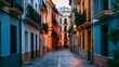 © Wuttichai - A narrow alleyway lined with colorful buildings  featuring balconies    and warm evening lighting