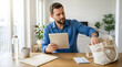 © Hamid - Focused bearded man using digital tablet while packing bag at wooden table