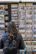 © Dani - Florence Italy Tourist Postcards Souvenirs Shopping Travel Market Culture Street. Tourist browsing postcards and souvenirs at a street display in Florence, Italy