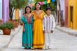 © kardaska - Mexican siblings wearing traditional clothing standing on colorful street