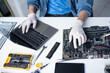 © Charlie's - Man Repairing Computer Hardware and Checking Internal Components in Professional Technology Workshop.