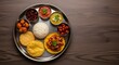 © Angga - Authentic Indian Thali Meal Served on a Traditional Metal Plate.