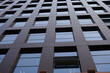 © Gloream - Modern office building with sleek glass and dark facade