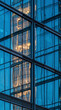 © Rendara Studio - Sunlit glass corner facade reflects a golden high rise tower in triangular pattern