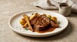 © PixelNova Studio  - Delicious slow cooked beef roast with roasted vegetables and gravy served on a ceramic dinner plate. Slow-cooked pork recipes