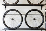 Cycling and bicycle maintenance, new bike wheels displayed on a shop wall rack for repair service or retail sales in a modern sports equipment store
