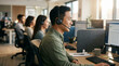 © atika - Asian male customer service agent wearing headset at desk in bright modern office, concept for technical support, remote communication and call centers