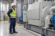 © ItziesDesign - Technician visually verifying industrial machine after service