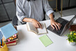 © Charlie's - Asian Man Adult Learner Using Laptop for Online Study and Education Technology Representing Professional Development and Lifelong Learning.