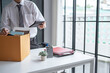 © Charlie's - Businessman Carrying Cardboard Box packing Stuff Resign Depress or carrying business cardboard box Change of job or fired from company resign.
