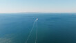 © Nasos Zovoilis - Cargo ship navigating vast blue ocean creating wake