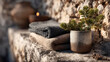© NATALIA - Rustic winter spa setup with folded towels and pine branches in a ceramic cup on a stone surface