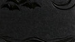 © Sam - Black halloween texture background with carved bats crescent moon and glitter