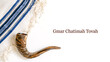 © Ihor - Yom Kippur celebration with shofar and tallit in a simple setting