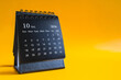 © Steppe-Walker - Desktop calendar showing October 2026 on yellow background, time management and planning concept