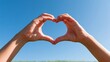 © Generative AI - Hands forming heart shape against clear blue sky