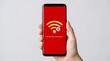 © animonday - Hand holding a smartphone displaying a red error screen with a no internet connection message and a disconnected wifi signal icon in a studio setting
