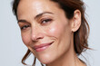 © JoeyMarut - Radiant middle aged woman smiling in close up three quarter face view showing natural skin texture and confident expression
