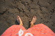 © Raul Navarro/Stocksy - Person standing barefoot on beach sand