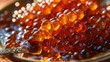 © swillklitch - Extreme macro close-up of glossy red orange salmon caviar fish roe with vivid spherical detail