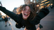© BlackBridge Media - Happy Young Woman Jumping with Arms Outstretched in City