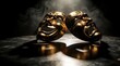 © Vadym - Gold comedy, tragedy theatrical masks sit on dark stage. Two metal drama masks under spotlight with smoke effect. Dramatic performance art props reflect on floor. Classical acting concept for theater