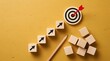© alex - Wooden cubes with upward arrows leading to a bullseye target, symbolizing progress and achievement