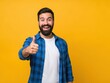 © Songpong - Smiling man giving thumbs up in blue jacket