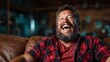 © Larisa AI - A jovial man with a beard bursts into laughter while sitting comfortably on a couch, creating a warm and inviting atmosphere embodying happiness and relaxation in a personal space.
