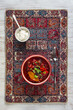 © sablinstanislav - Traditional beetroot soup borscht with sour cream on an ornamental mat. Top view flat lay of red beet soup in a bowl served with metal spoon and sour cream on an ethnic pattern background.